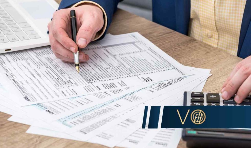 Specjalista wypełnia deklarację podatkową i używa kalkulatora