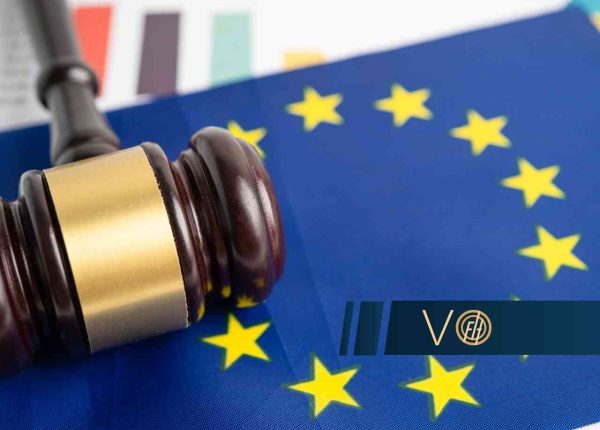 Gavel resting on an EU flag, symbolizing European Union law or regulation.