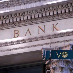 Close-up of a historic bank façade with ornamental carvings and the word BANK in gold letters.