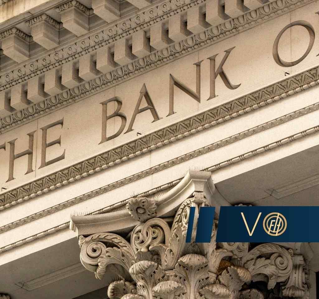 Facade of a bank with the words THE BANK OF carved into stone and ornate friezes.